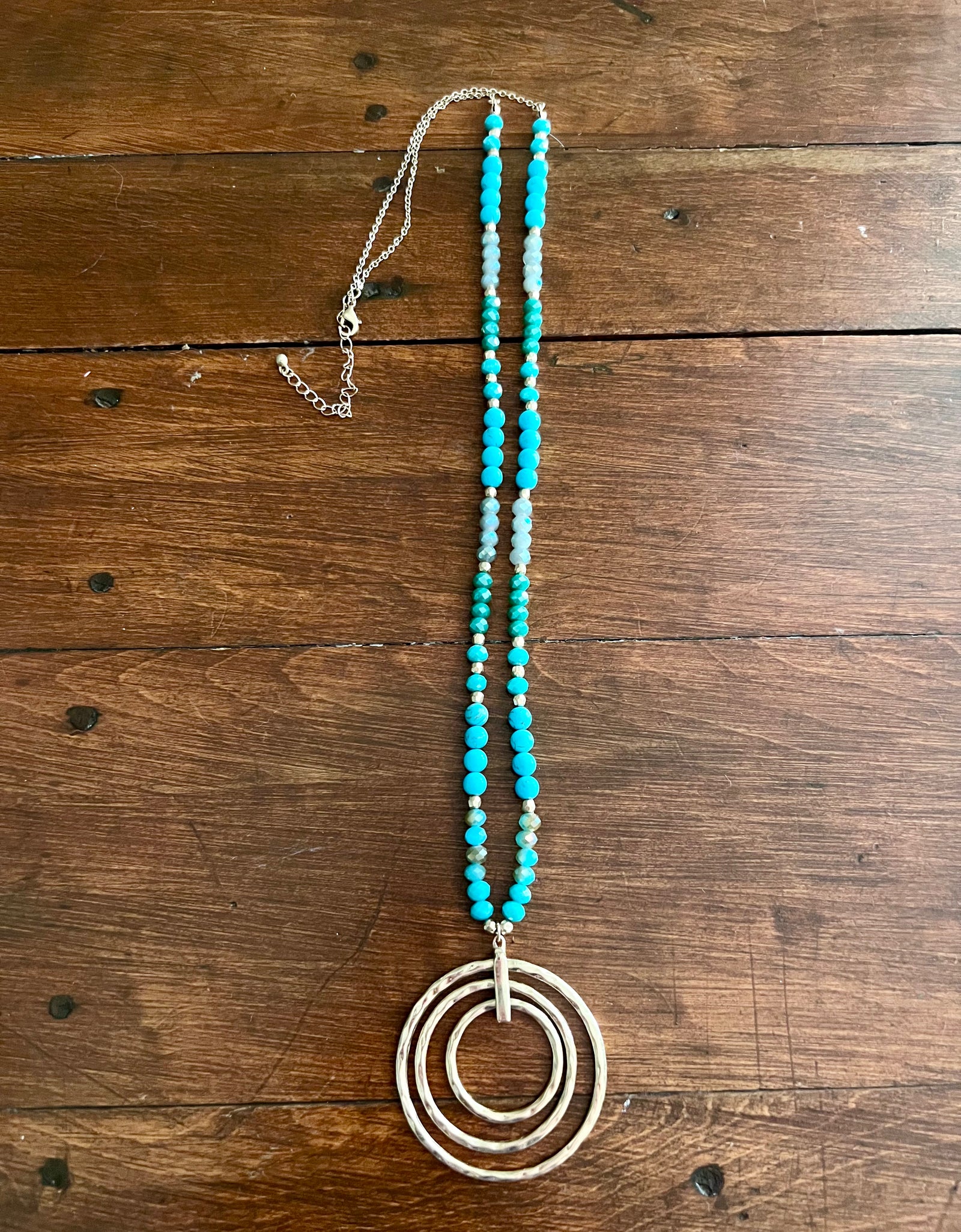 Rant & Rave turquoise beaded necklace with gold multiple rings
