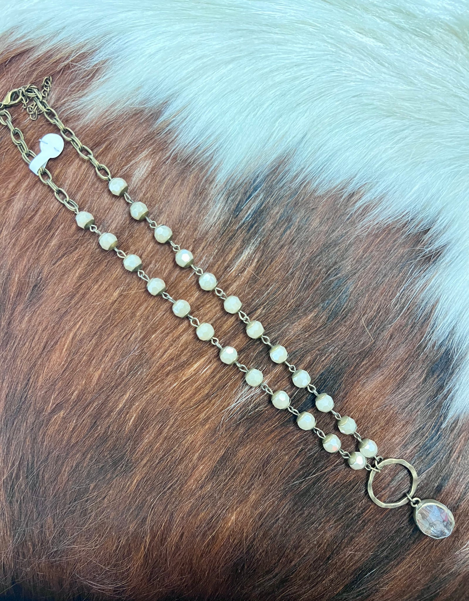 AC beaded chain necklace with gold ring and drop pendant